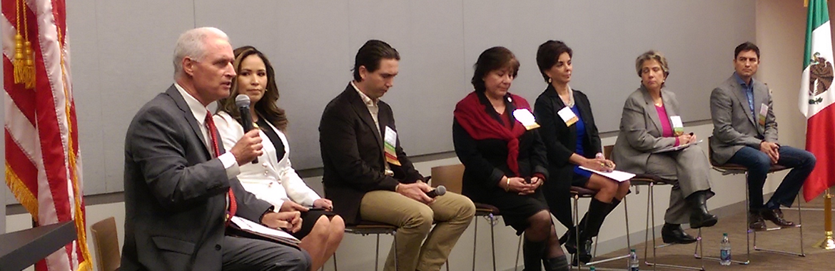 A panel of speakers on a stage.