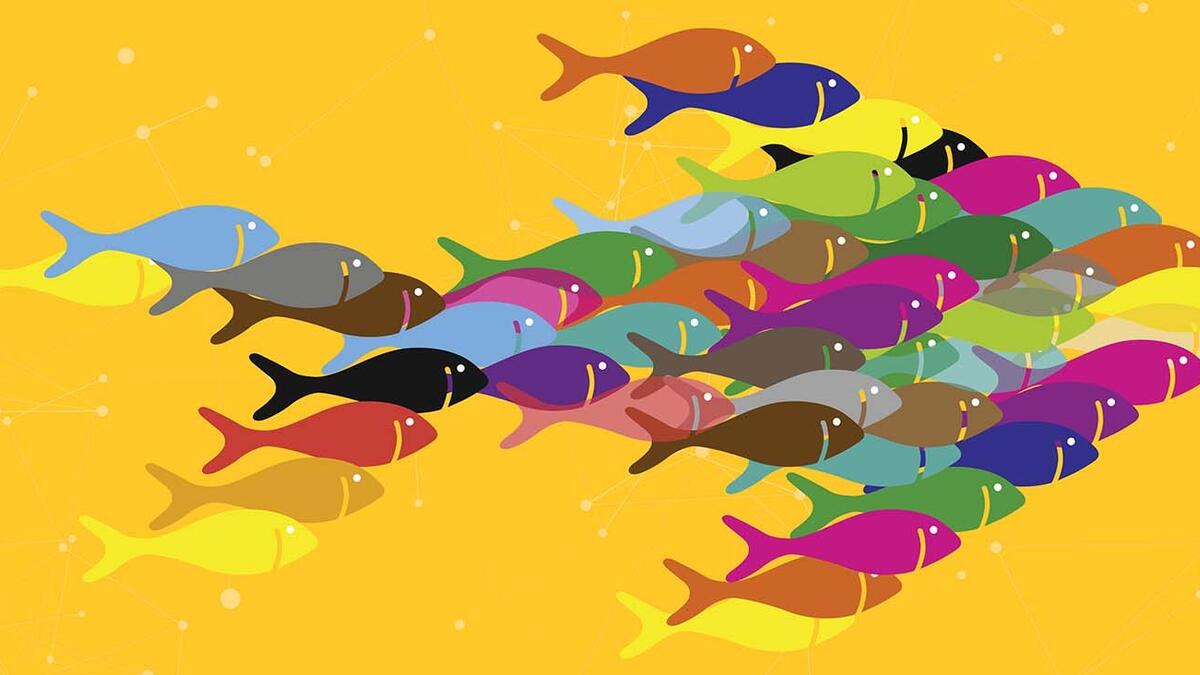 Illustration of a group of fish swimming together in the shape of one big fish