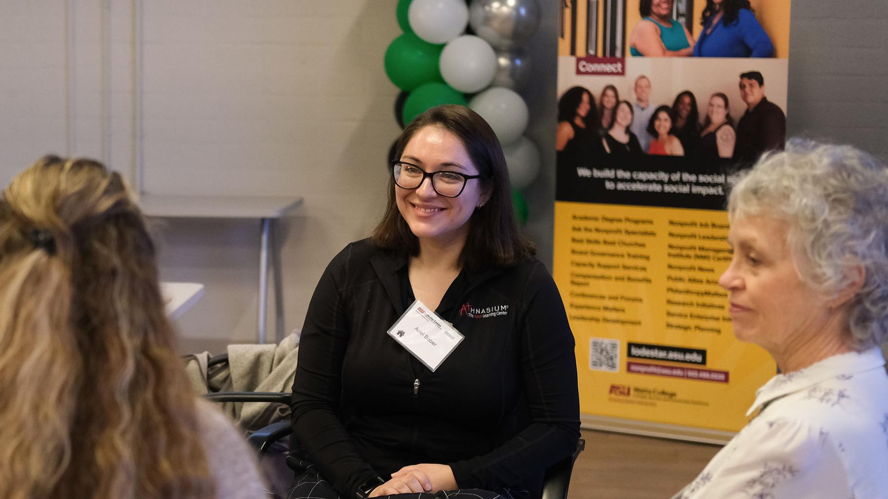 Ariel Baber talks to fellow participants at a Cogenerational Service Academy session.